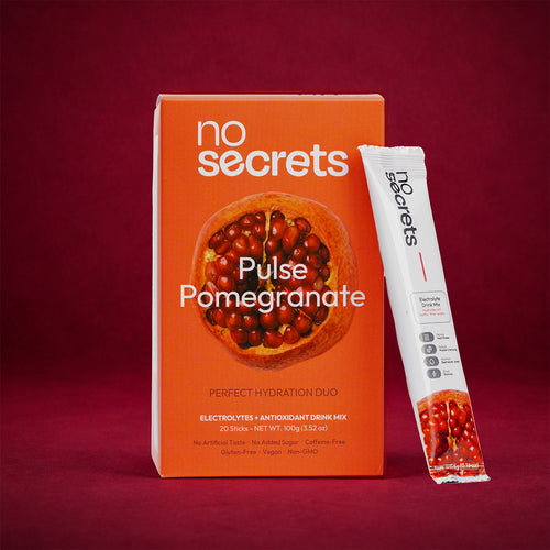 no secrets Pulse Pomegranate drink mix packaging on a red background