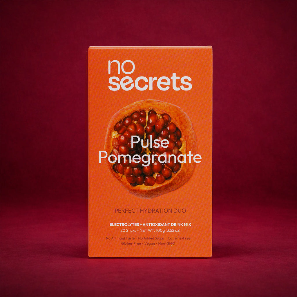 Orange packaging of 'no secrets' Pulse Pomegranate drink mix on a red background